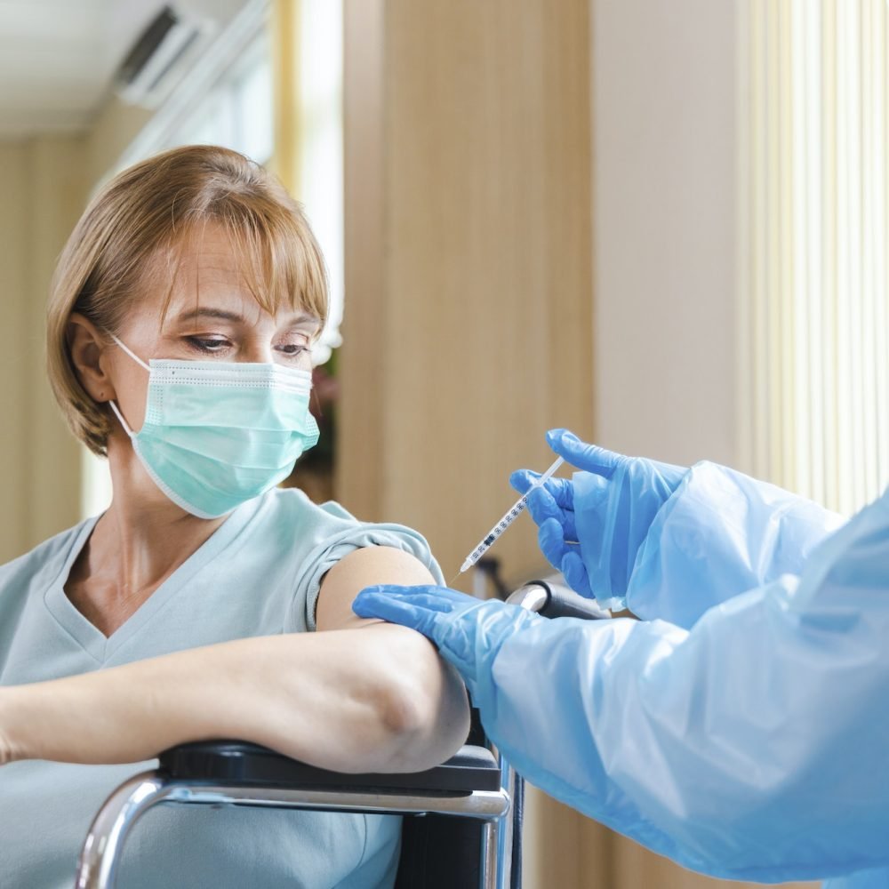 elderly-woman-patient-getting-covid-19-or-coronavirus-vaccine-in-a-wheelchair-at-the-hospital-